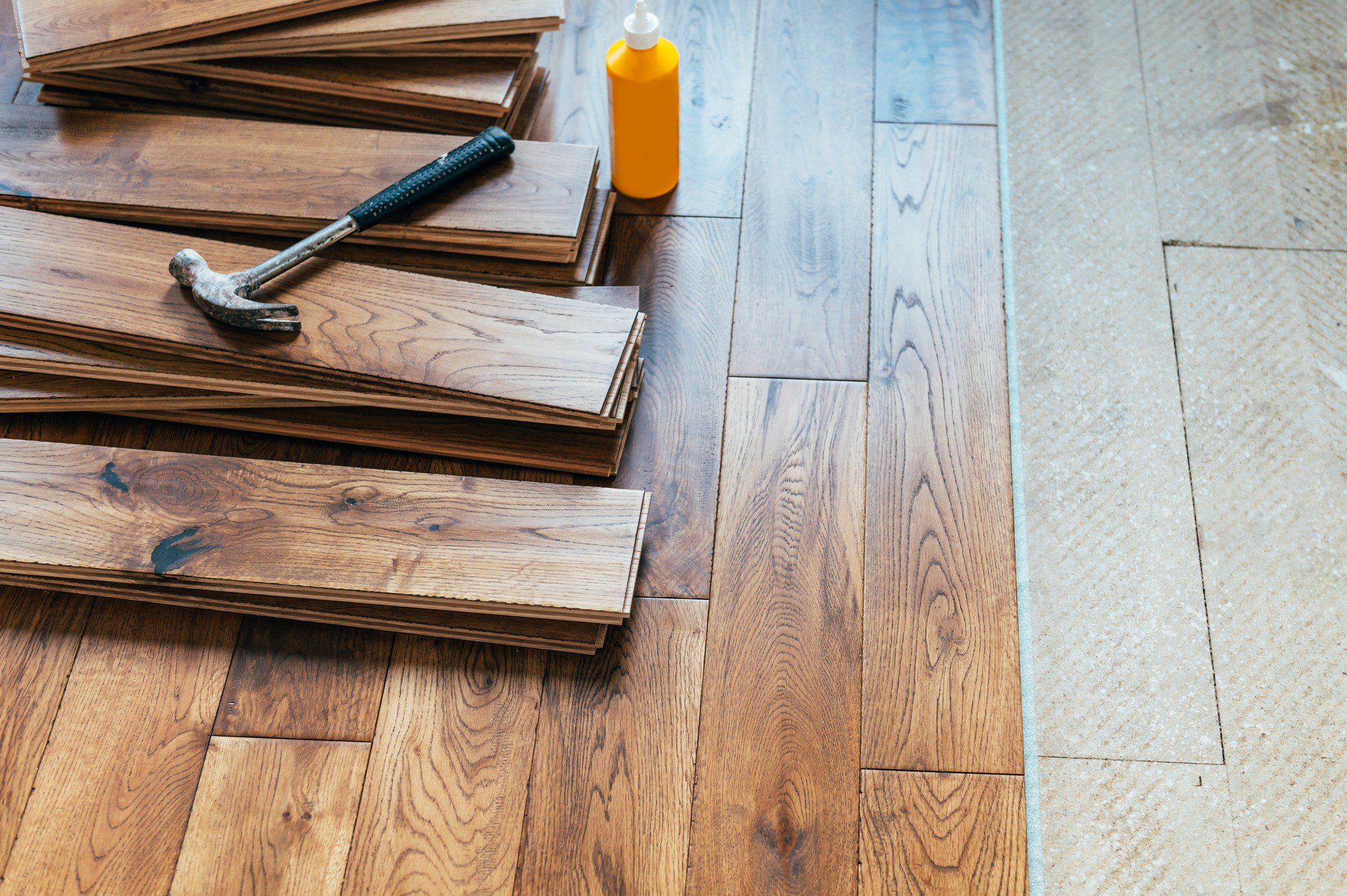 Sure, here's a detailed alt text description for the image:"A close-up view of a room featuring solid oak wood flooring. The planks are arranged in a straight, horizontal pattern, showcasing the wood's natural grain and rich, warm tones of honey and caramel. The wood has a smooth, polished finish that reflects light, enhancing the room's warmth and elegance. Slight variations in colour and texture are visible, highlighting the natural characteristics of the oak. The image captures the fine craftsmanship and detail in the flooring, suggesting a high-quality, durable material suitable for a cosy, inviting living space."